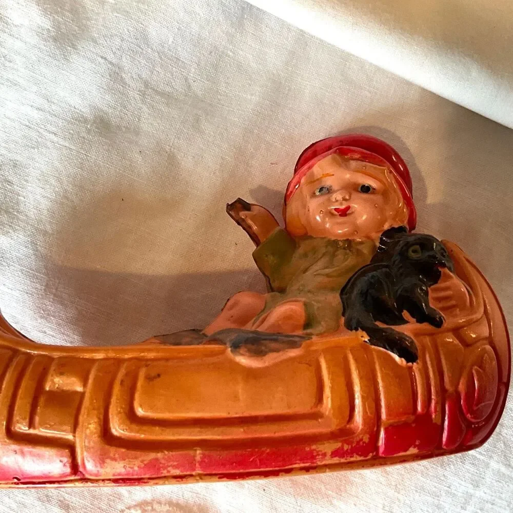 Rare 1920's Antique celluloid toy girl in a canoe; don't miss her!